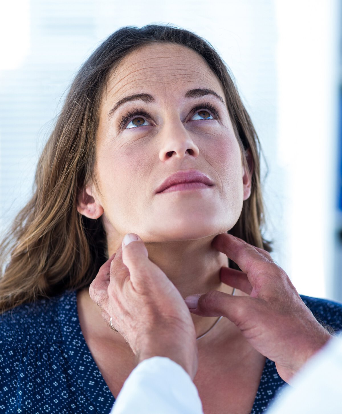 Pembroke pines doctor examining the throat of female patient