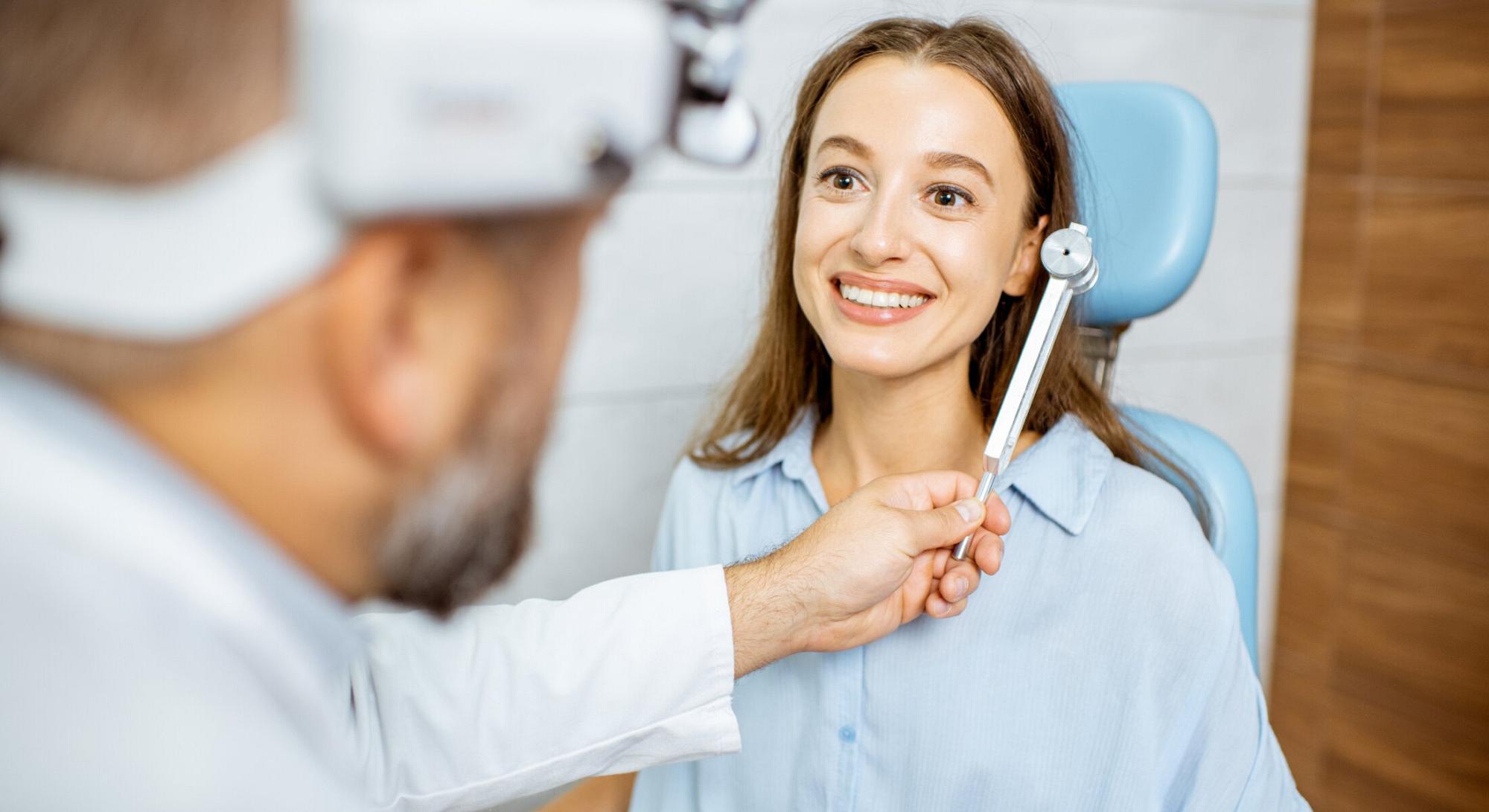 doctor checking woman's hearing